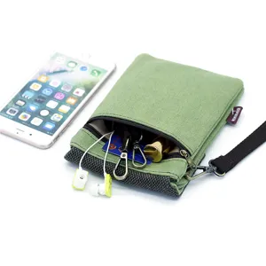 Green canvas mini crossbody phone bag with zipper pocket and wrist strap, main view.