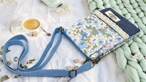 Floral fabric crossbody phone bag with denim patchwork and lace trim, casual shoulder purse.