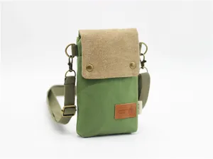 Canvas crossbody phone bag in green and khaki with adjustable strap and metal hardware.