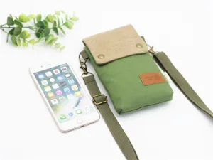 Green canvas cross-body phone bag with brown flap, adjustable strap and multi-layer design.