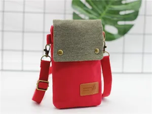 Small canvas crossbody phone bag in red and khaki with metal buckles for daily use.