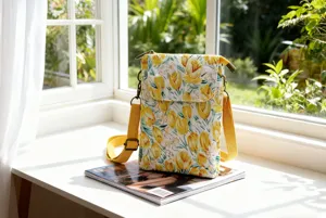 Floral print crossbody phone bag with adjustable yellow strap and retro metal hardware details.