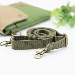 Green canvas crossbody phone bag with adjustable shoulder strap, minimalist lightweight design.