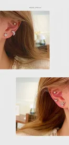 Gros plan de boucles d'oreilles scintillantes en zircone avec motifs d'étoile, lune et cygne.