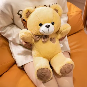 Cute teddy bear plush toy with bow tie and heart detail, soft stuffed animal doll for gifts.