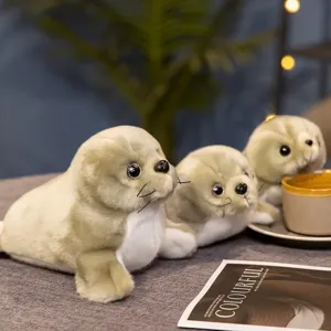Close-up detail shot of cute simulation seal plush toys arranged on the table with soft texture.