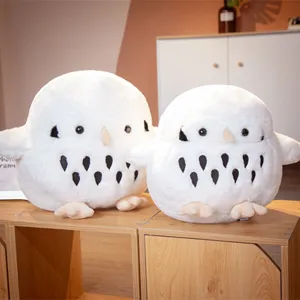 Close-up of white owl plush toy, soft stuffed animal pillow with cute details and fluffy texture.