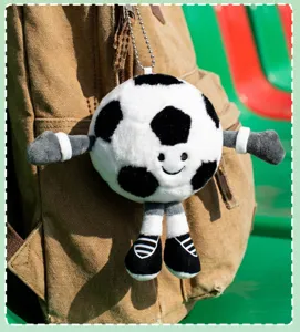 Detailed close-up view of cute plush soccer ball keychain pendant, soft cartoon toy bag.