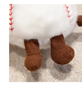 Close-up detail of cute baseball plush pendant, soft white fur and brown corduroy feet.