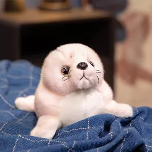 Close-up view of the cute simulation seal plush toy, soft white fur texture details.