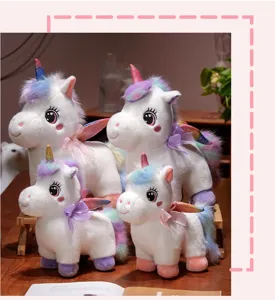 Cute rainbow unicorn plush toy detailed view showing soft white fabric and colorful fluffy mane.