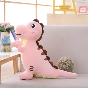 Close-up detail of the cute pink dinosaur plush toy sitting on a cozy sofa, soft filling.