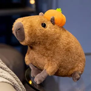 Cute capybara plush toy with small pumpkin hat, soft stuffed animal doll details, cozy room decor.