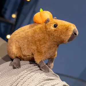 Cute capybara plush toy with pumpkin hat, soft stuffed animal doll for kids and home decor.
