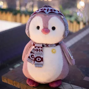 Cute pink penguin plush toy with knitted hat and scarf, soft stuffed animal gift for girls.