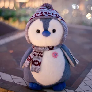 Cute penguin plush toy with knitted hat and scarf, soft stuffed doll for kids and girls.