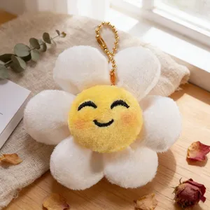 Primo piano del dettaglio ciondolo girasole in peluche, petali morbidi e viso ricamato.