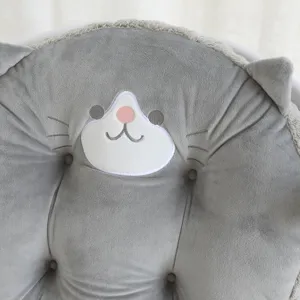 Grey cute cat plush cushion detail, soft round chair pad with embroidered face and ears.