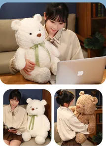 Cute ribbon teddy bear plush toy detail shot, soft fluffy stuffed animal for kids and gifts.