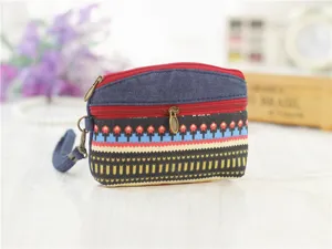 Ethnic style canvas coin purse with double zippers, denim patch and convenient wrist strap.