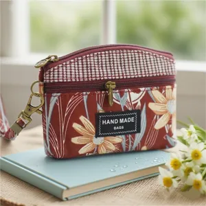 Fabric coin purse detail, plaid and floral pattern with double zippers and metal hardware.
