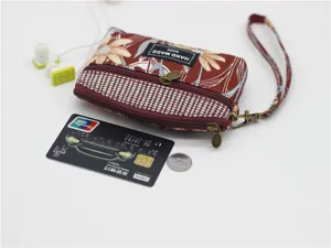 Vintage floral fabric coin purse with double zippers, handy wrist strap, and compact design.
