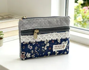 Close-up detail of the multi-layer cotton fabric coin purse with floral pattern and lace.