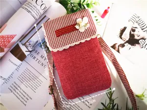 Red cotton linen cell phone crossbody bag detail, houndstooth flap with floral lace trim.