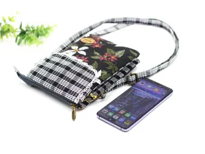 Cotton floral crossbody phone bag with multi-layer storage, plaid front pocket and strap.