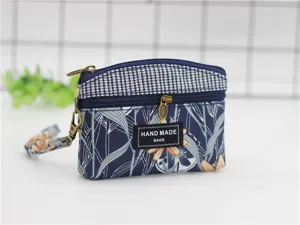 Canvas coin purse with double zippers, floral pattern and wrist strap for daily use.