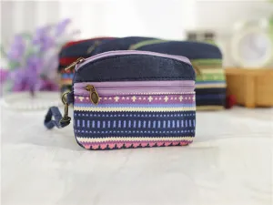 Ethnic style fabric coin purse close-up, featuring double zippers and a handy wrist strap.