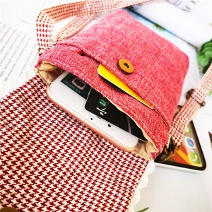 Red linen crossbody phone bag with houndstooth strap, compact and stylish storage for daily use.