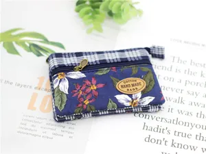 Floral pattern multi-layer cotton coin purse with zipper closure and handmade label.