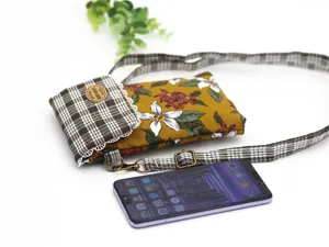 Cotton floral crossbody phone bag detail showing multi-layer design and adjustable strap.