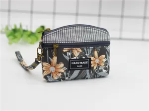 Floral checkered fabric coin purse with double zippers, wrist strap and compact daily storage.