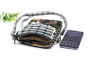 Detailed close-up view of the multi-layer cotton crossbody phone bag with classic plaid pattern.