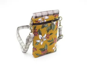 Floral pattern fabric mobile phone crossbody bag detail showing flower print and strap.