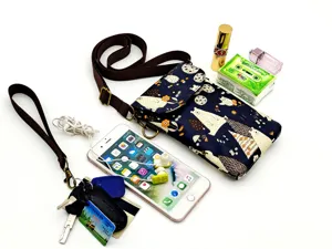 Women dark blue crossbody phone bag with cute cartoon animal print and adjustable strap.