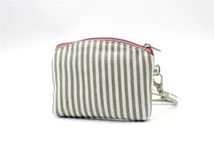 Detailed view of the striped fabric coin purse, featuring a durable zipper and wrist strap.