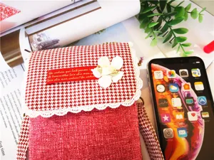 Red houndstooth mini crossbody phone bag with floral lace trim and chic fabric design.