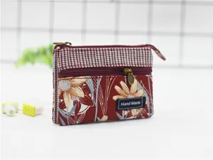 Multi-layer cotton coin pouch with floral and plaid pattern, featuring secure zippers and compact design.