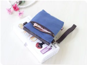 Blue canvas crossbody phone bag with leather flap, stylish mini clutch for daily use.