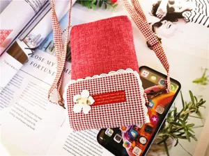 Red cotton linen crossbody phone bag with houndstooth flap, lace trim, and floral detail.