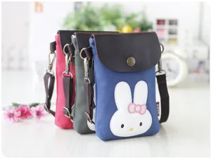 Canvas mobile phone crossbody bag detail, cute rabbit embroidery, leather flap, close-up shot.