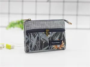 Fabric coin purse detail, multi-layer design with zipper and floral pattern for daily use.
