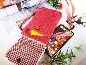Red cotton linen crossbody phone bag detail showing multi-layer design and metal clasp.