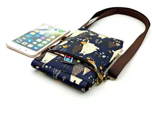 Waterproof multi-layer crossbody phone bag with cute bear print and adjustable brown strap.
