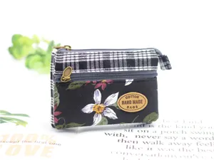 Close-up detail of the multi-layer cotton coin purse with plaid and floral patch design.
