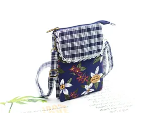 Detailed view of the multi-layer cotton crossbody bag with floral print and plaid flap.