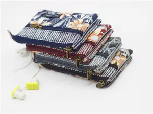 Detailed view of multi-layer fabric coin purse with floral pattern and 4 zippered pockets.